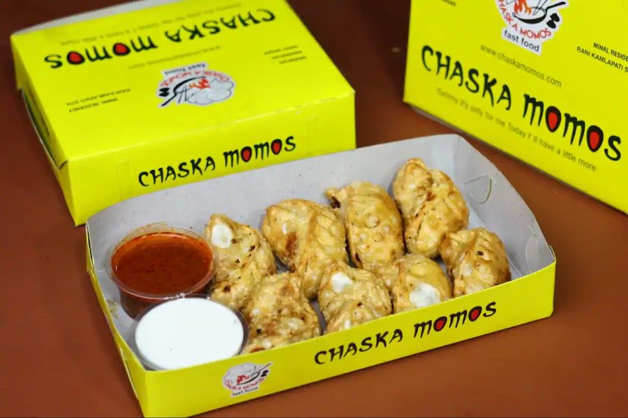 Golden fried momos with red chutney and mayo