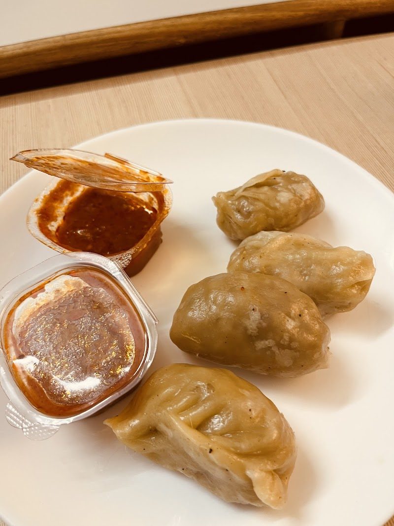Fried momos on a plate with two dips