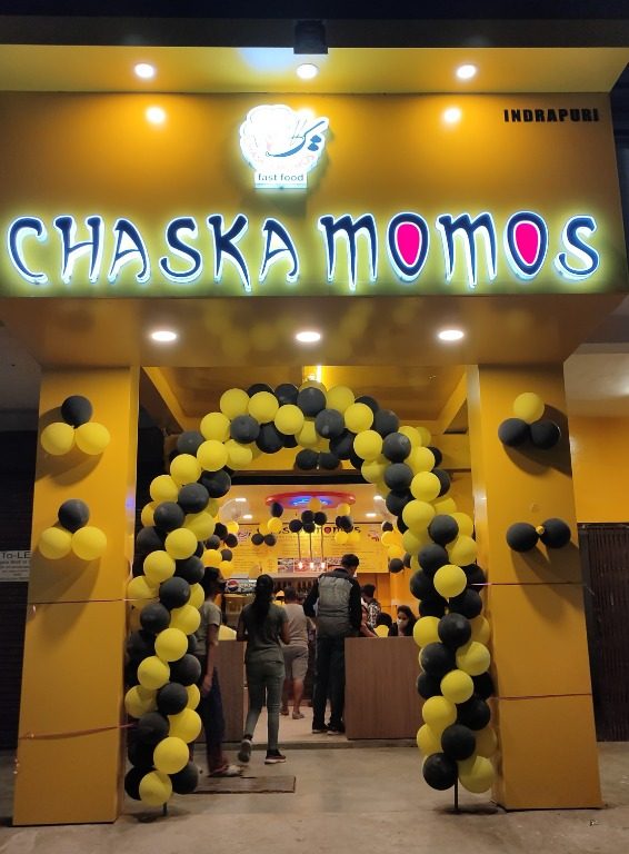 Chaska Momos outlet decorated with yellow and black balloons